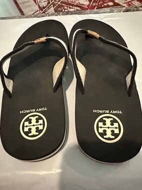 Tory Burch Black Flip Flops with Gold Logo Accent